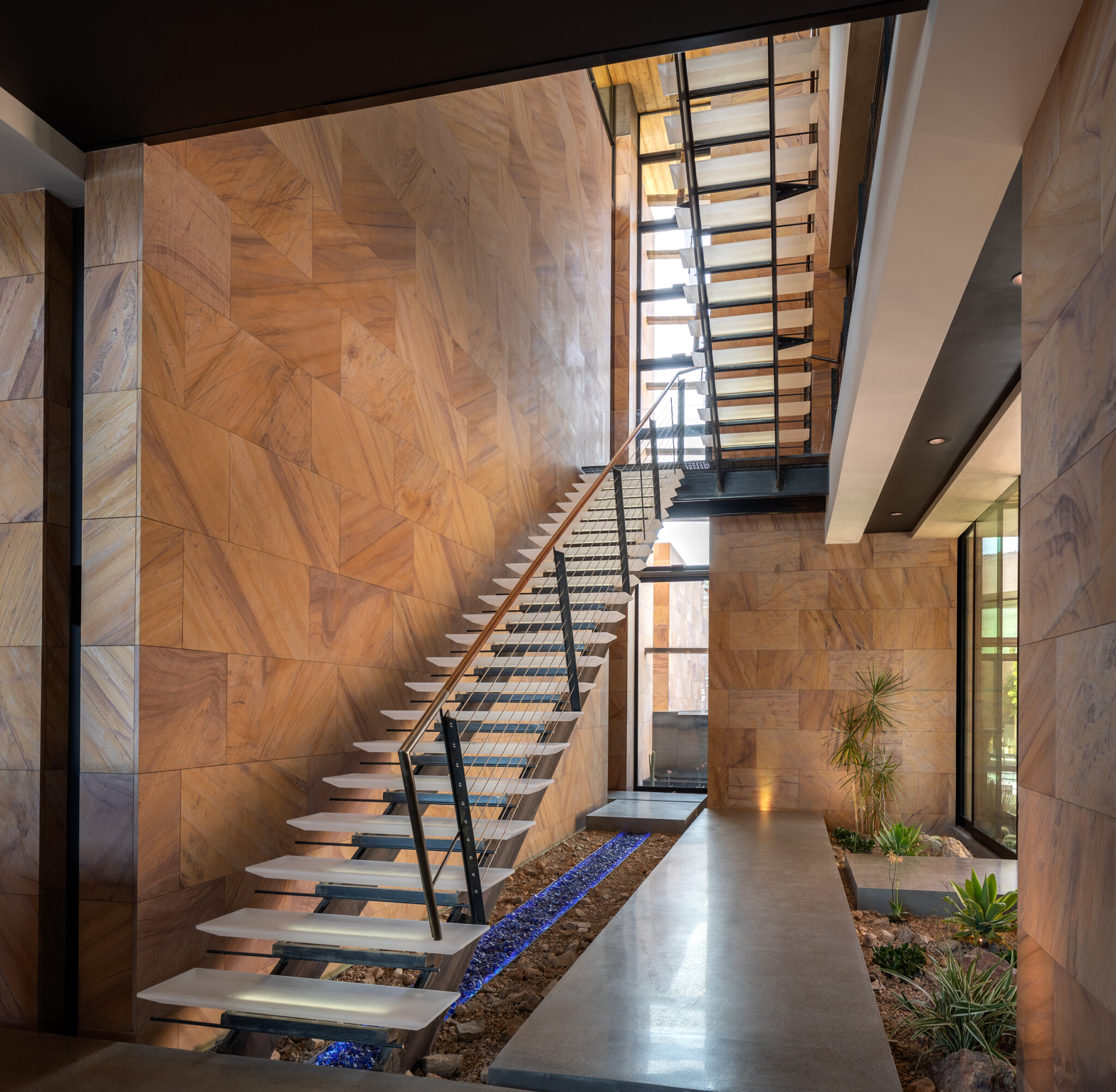 A custom home interior featuring a free standing metal staircase created by stairs contractor, JD Stairs