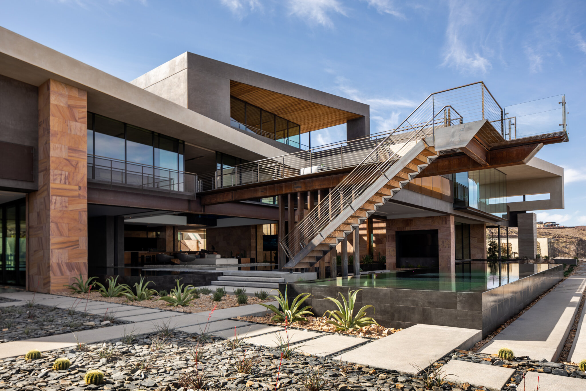 A custom home featuring an exterior steel stair created by stairs contractors, JD Stairs