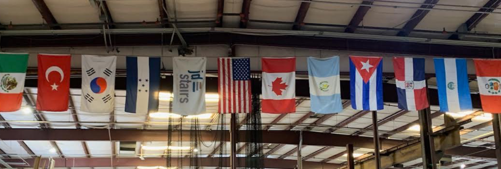International flags hung in rafters, JD Stairs has a very diverse culture inside the company.